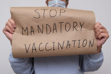 A woman holding a poster, sign No mandatory vaccination, she expresses a protest against forced vaccines, vaccination