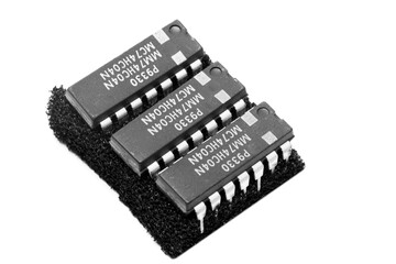 3 x 14 pin ICs punctured on an antistatic base viewed from above and with a white background