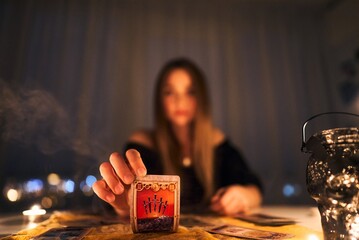 Woman reading tarot cards in spiritual room