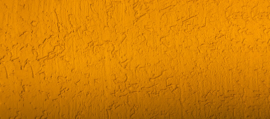 Finishing of facade of house bark beetle golden color. Mustard-colored background - decoration of facades with decorative plaster. Topic - construction