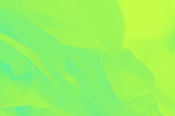 Green yellow shine neon color flying fabric texture, abstract blurred background