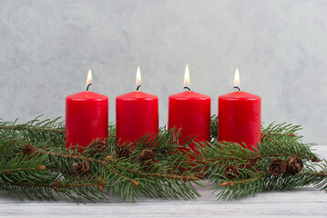 Fototapeta na wymiar Red candles on a advent wreath, christmas decoration with candlelight