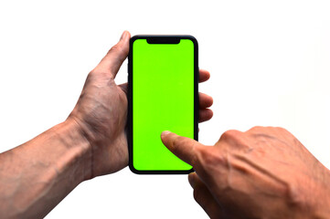 Photo of two hands holding a mobile device - iPhone template with green screen to add a customized image or text with chroma key - Smartphone blank screen to show an app, game or website on display