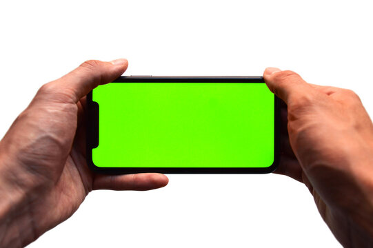 Photo of two hands holding a mobile device - iPhone template with green screen to add a customized image or text with chroma key - Smartphone blank screen to show an app, game or website on display