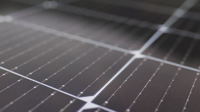 View from the camera moving next to the solar panels. Close-up of modern photovoltaic solar battery panels. Solar panel, photovoltaic, alternative electricity source. Efficient ecological solar farm.
