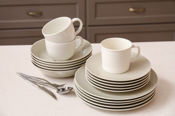 Set of clean dishes on table in kitchen
