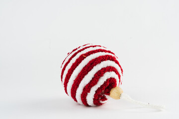 Christmas ornament isolated on white background. Polka dots to hang on Christmas trees to celebrate the arrival of Santa Claus. Red ball.