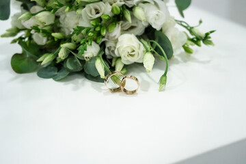 wedding rings and bouquet of roses
