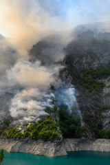 Fototapeta na wymiar Wildfire at Piva Lake in national park of Montenegro