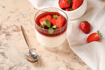 Delicious panna cotta with strawberry and mint in glass on light background, closeup