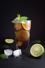 The concept of making a refreshing summer cocktail with ice, cola and mint for a cafe and restaurant.
