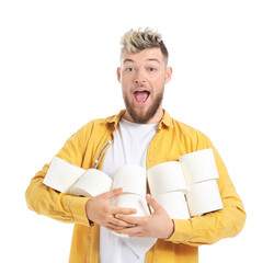 Happy young man with many rolls of toilet paper on white background