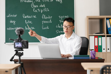 Asian teacher conducting English lesson online