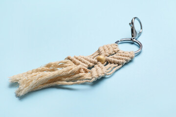 Handmade cotton keychain on color background, closeup