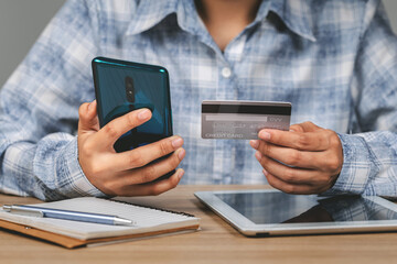 Business woman hands holding credit card and using mobile smart phone , online shopping, woman happy.