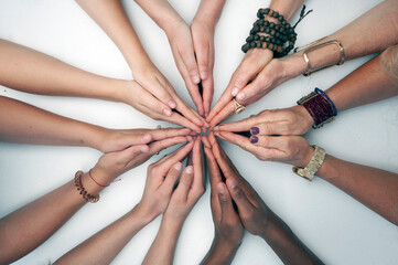 Womenâ€™s hands in a geometric connection design photographed on a white background.