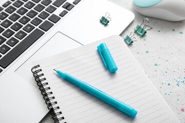 Notebook, pen and laptop on table, closeup