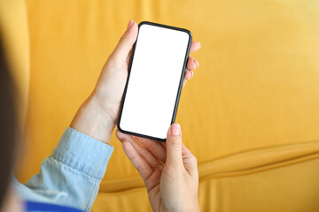 Businesswoman with mobile phone in office, closeup
