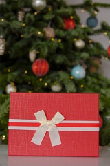 Christmas Surprises and gifts for the winter holidays. Red gift boxes on Christmas tree background.Christmas and New Years holiday.Merry Christmas.