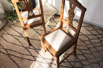 Oak dining chairs  under sunlight isolated in a cozy and stylish room 