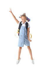 Jumping little schoolgirl on white background