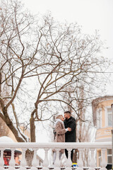 Fototapeta na wymiar a man and a woman hug on a winter street. couple in love.