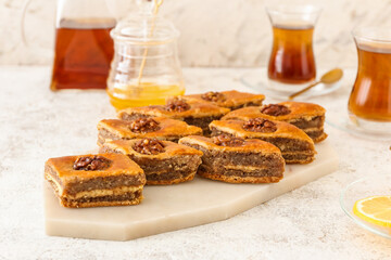 Board with tasty baklava on table