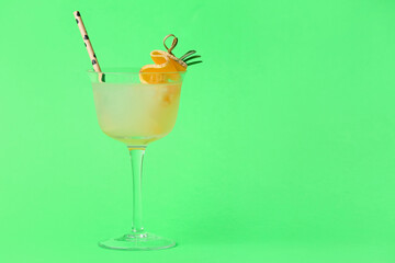 Glass of delicious melon cocktail on green background