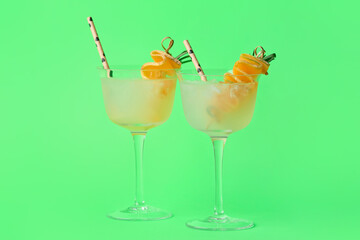 Glasses of cold melon cocktail on green background