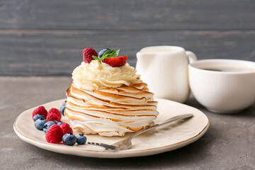 Plate with tasty Pavlova cake on grunge background