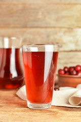 Glass of delicious dogwood drink on table