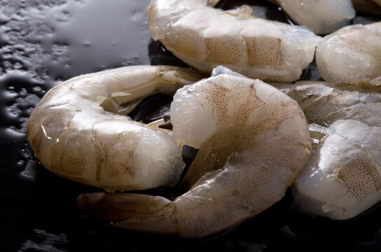 Macro Image of Fresh Raw Shrimps on Dark Wet Counter