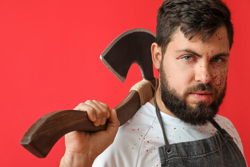 Man dressed as butcher for Halloween on color background