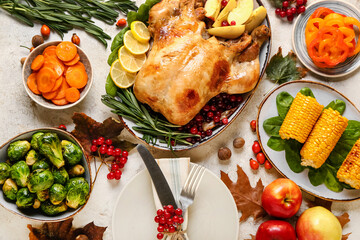 Composition with tasty baked turkey and different food for Thanksgiving Day on light background