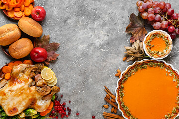 Tasty baked turkey, pumpkin pie and different food for Thanksgiving Day on grunge background