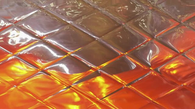 Orange-colored water flows down the glass into a cage, with the texture of a glass block. Beautiful Background for the video.