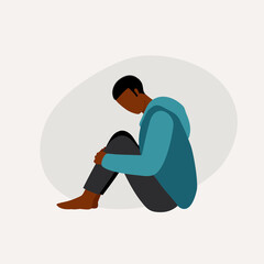Young Black Man In Depression With His Head Facing Down, Sitting On Floor And Hugging His Knees.