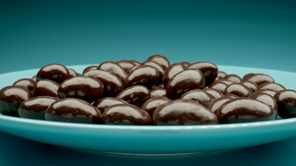 MACRO: Many chocolate candies on a blue dish - 460215169