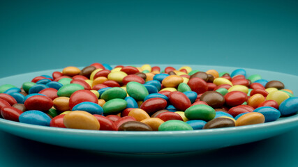 Many colored candies on a blue dish, Close Up - 460215177