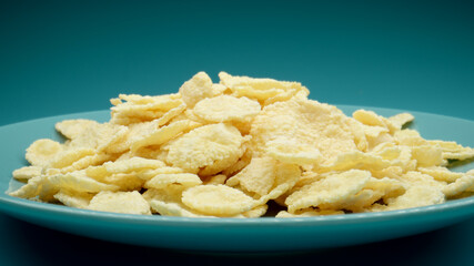 Sweet corn flakes on a blue dish, Close up - 460215184