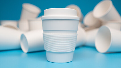 ZERO WASTE: Close up of reusable white mug and a lot of paper cups on a blue background - 460215187