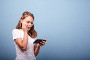 a girl with a smartphone on a blue background