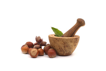 Hazelnuts and wooden rustic-style mortar and pestle