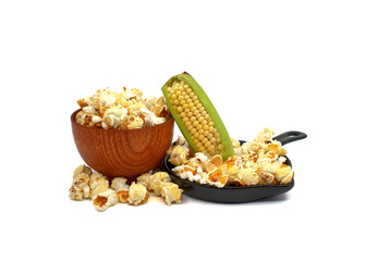 Fresh corn on the cob with bowls of popcorn snack