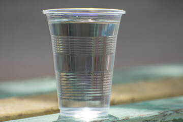 A glass of clean water in the morning light. Low contrast photo.