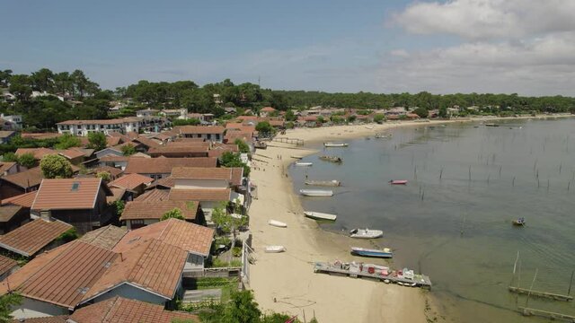 Oyster fishing village of Canon at the middle inner coast of Cap Ferret in France, Aerial flyover shot