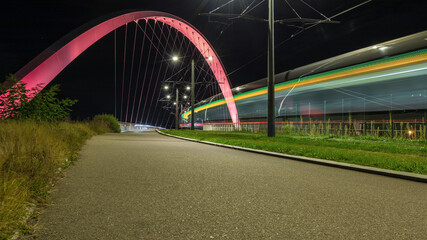 Fototapeta na wymiar streaks of lights from the tram passing over the bridge in Strasbourg in France