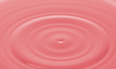 Water droplet  on water surface with pink light effects background. Ideal for background,wallpaper etc.,