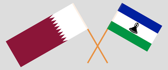 Crossed flags of Qatar and the Kingdom of Lesotho. Official colors. Correct proportion
