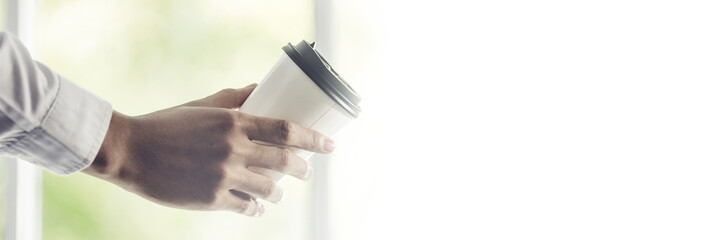 white coffee cup in hand